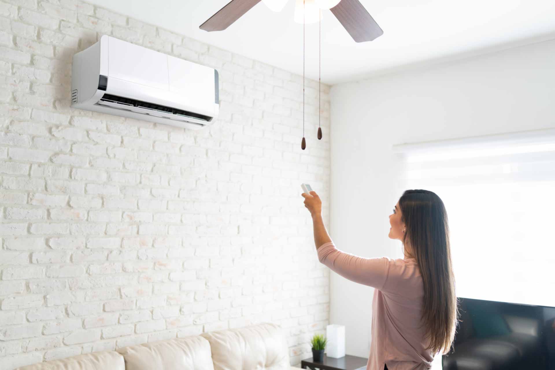 Woman turning on AC in home