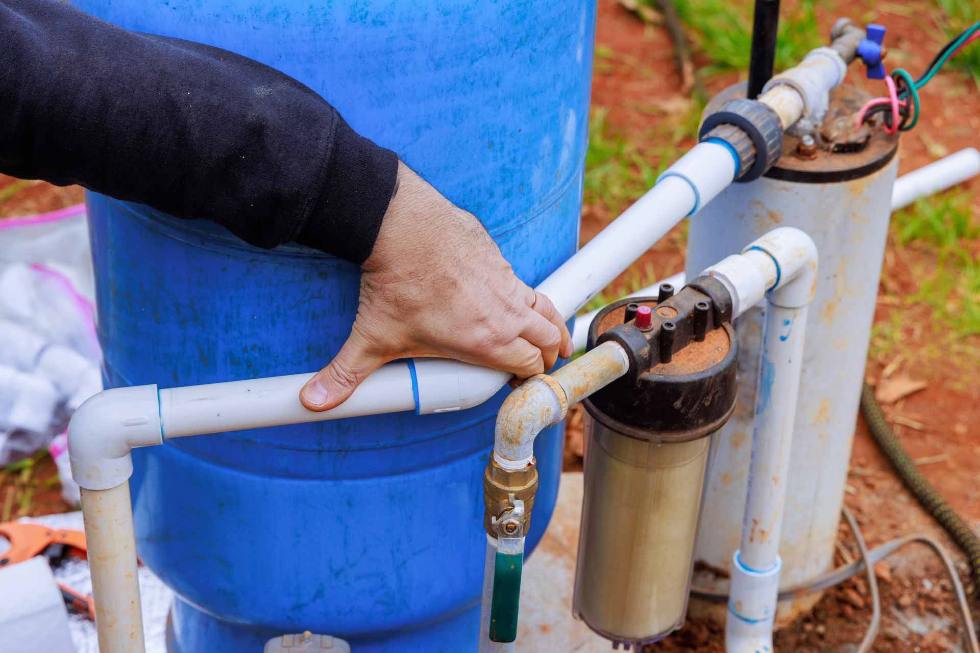 Man inspecting well pressure tank